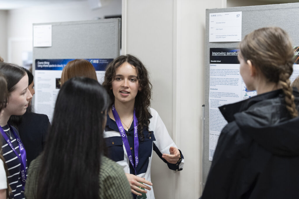 Girl presenting research at IRIS conference