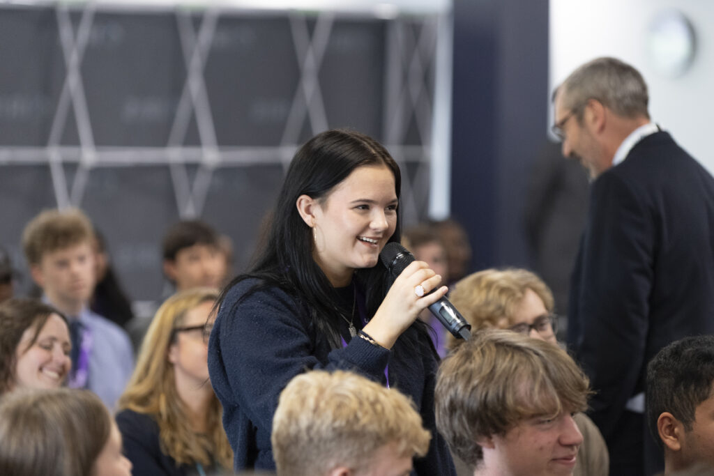 Student asks a question at conference